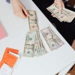 business professionals discussing financial charts and documents related to cash management techniques in a modern office setting