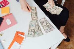 business professionals discussing financial charts and documents related to cash management techniques in a modern office setting