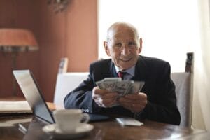 A retirement savings chart and a calculator on a desk, representing smart retirement investing moves for 2026.