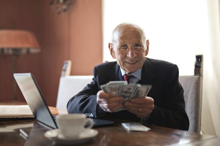 A retirement savings chart and a calculator on a desk, representing smart retirement investing moves for 2026.