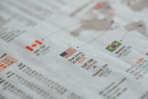 Economists analyzing charts and graphs in a会议室, focusing on recession indicators to forecast economic downturns.